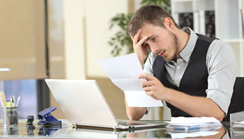 worried man reading a letter